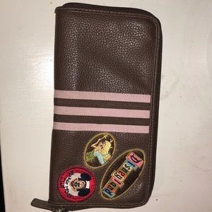 A brown and pink leather Disneyland resort wallet